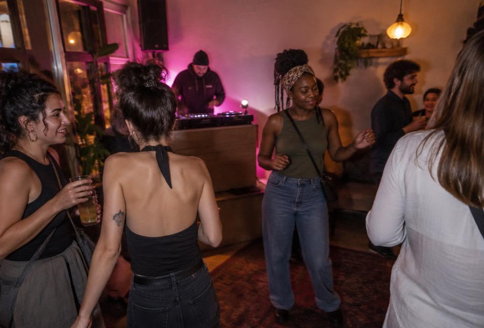 Illustrative Waimz music night with adults dancing in a neighborhood venue
